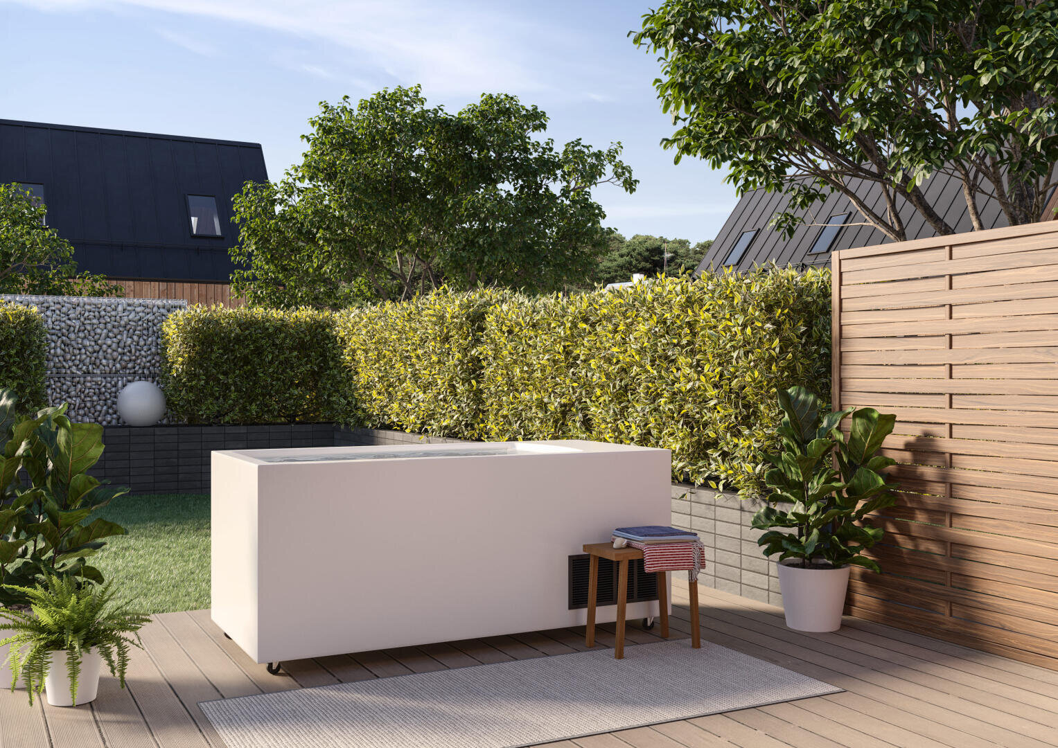 A modern outdoor patio features a rectangular white hot tub surrounded by lush green hedges, potted plants, a wooden privacy screen, and contemporary houses in the background under a clear sky.