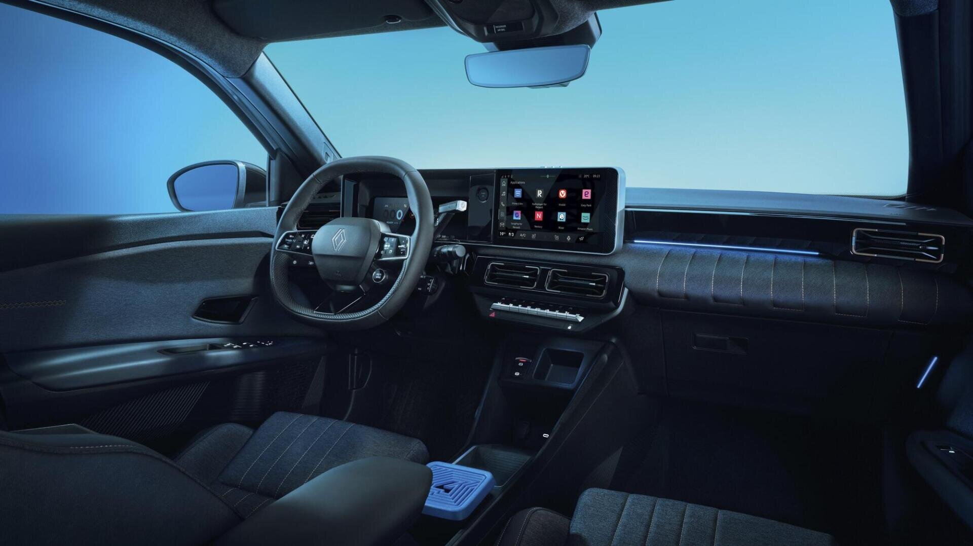 Modern car interior with black dashboard, digital display with app icons, touchscreen controls and blue accent lighting against a blue background that can be seen through the windows.