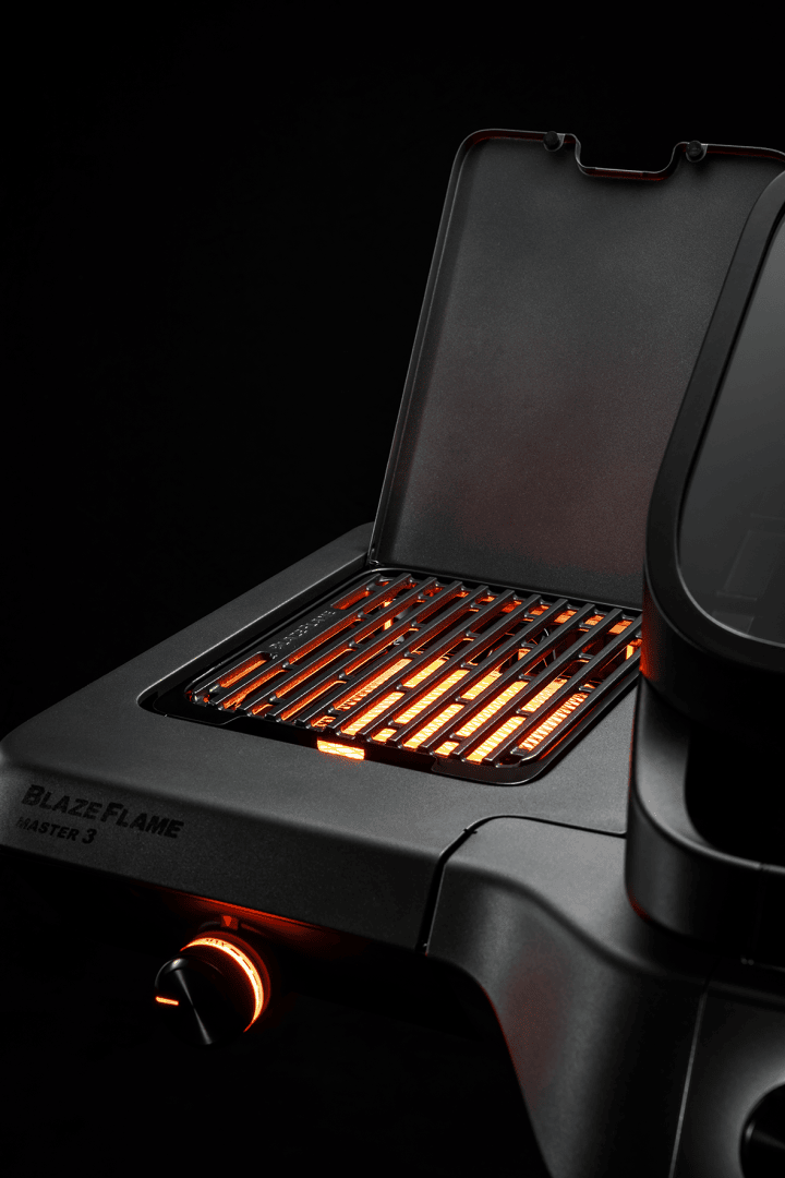 Close-up of an open electric grill with red illuminated heating elements and a visible control knob against a dark background. The grill lid is partially open and provides a view of the illuminated hob.