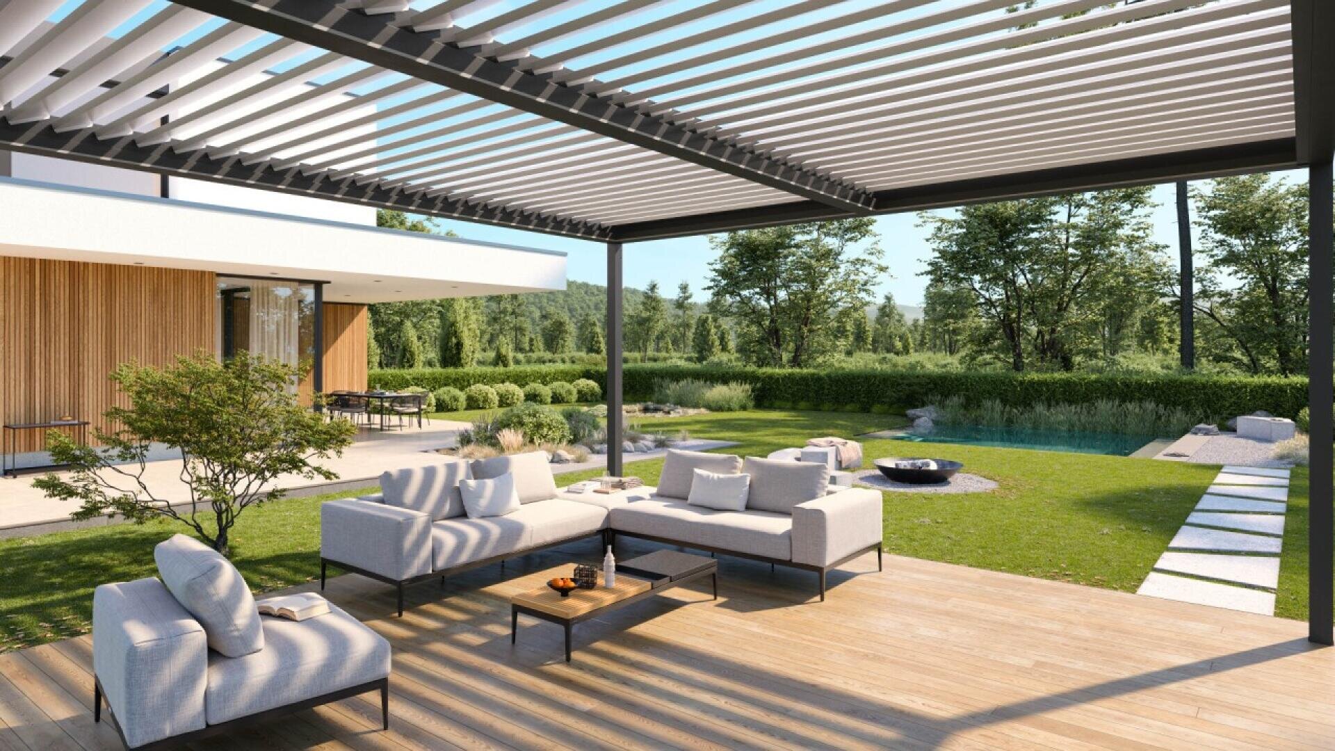 A modern patio with white outdoor sofas under a slatted pergola overlooks a lush green lawn, a small tree, a stone path, and a pond in a spacious backyard garden.