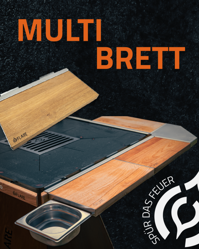 A modular cutting board system made of wood with several sections, a metal tray and the lettering MULTI BRETT in large orange letters. The SPUR DAS FEUER logo is in the bottom right-hand corner.