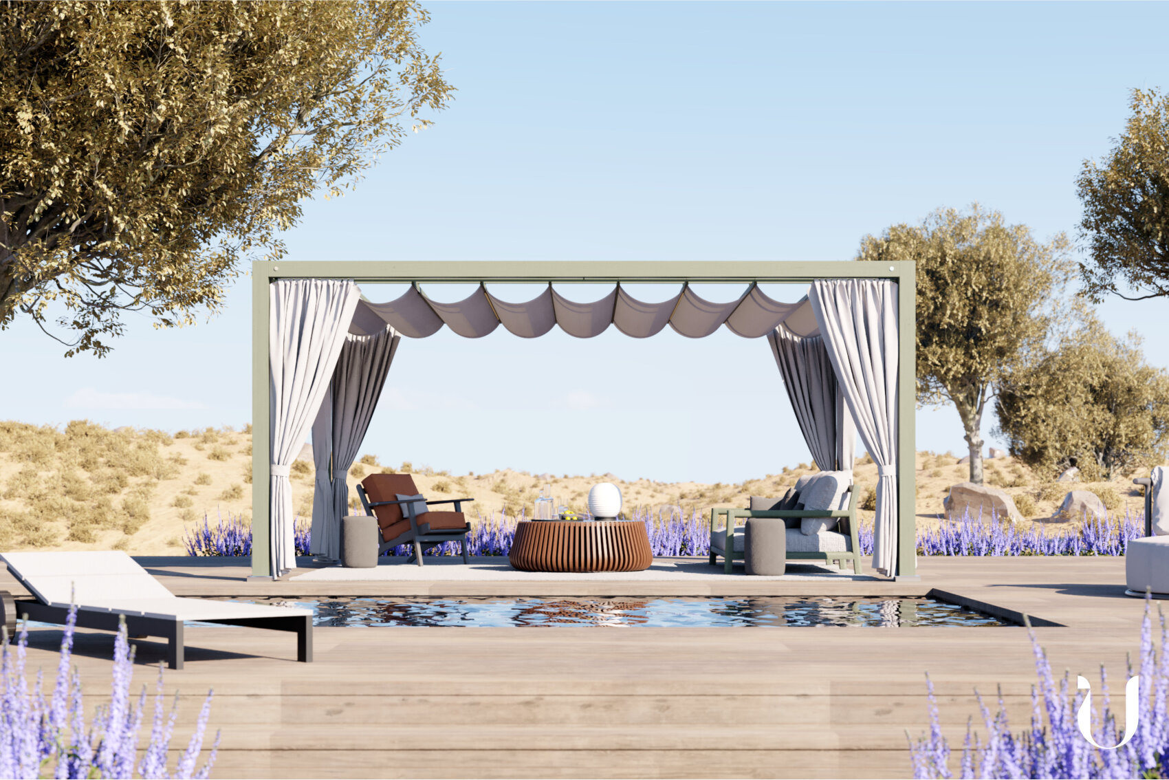A poolside cabana with draped curtains, lounge chairs, and a round table sits on a wooden deck surrounded by lavender plants, with trees and a desert landscape in the background under a clear blue sky.